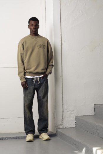 A model with Les Chevaux Sauvages Crewneck by Goodies Sportive