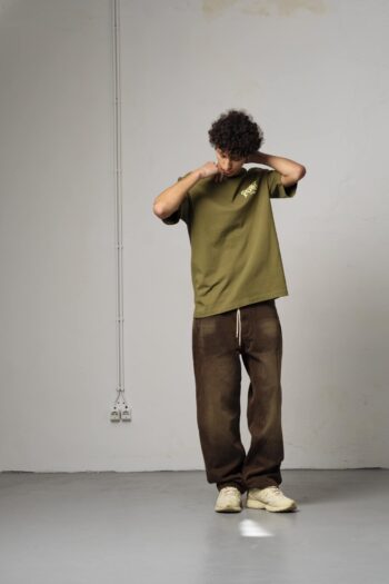 A model with Goodies Sportive Khaki Tee by Goodies Sportive
