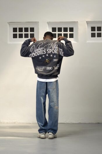 A model with Radio 24:7 Crewneck by Goodies Sportive