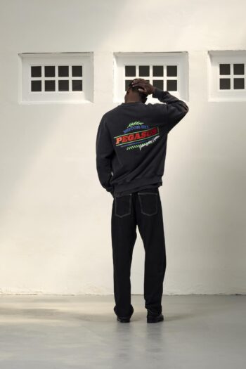 A model with Motor Oil Black Crewneck by Goodies Sportive